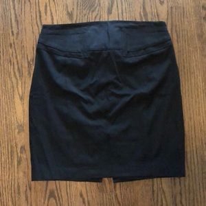 Black stretch pencil skirt with back buckle detail